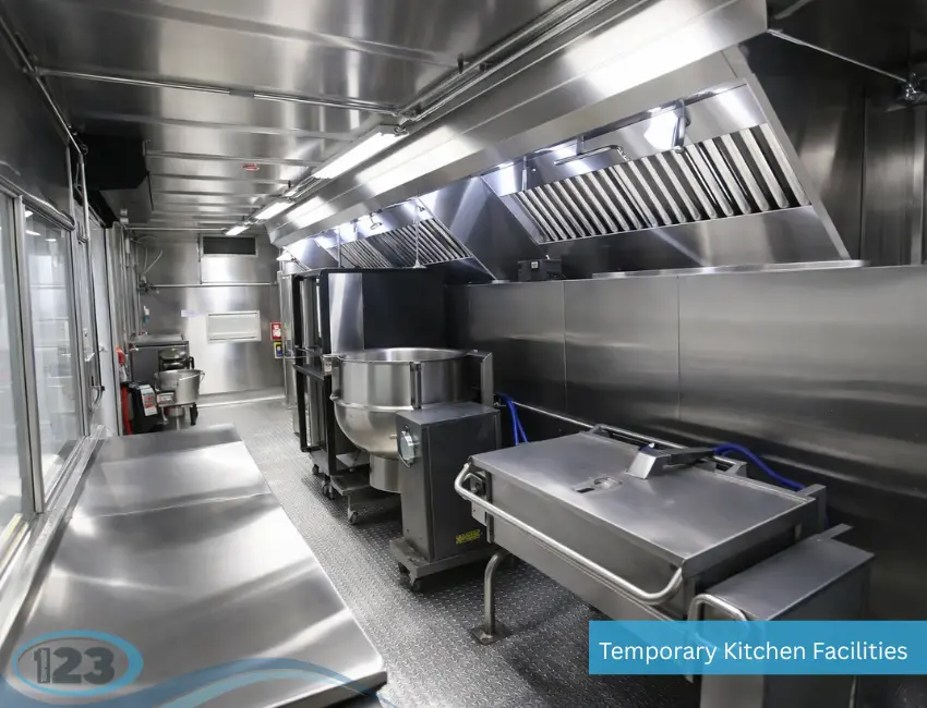 Large mobile kitchen rental with commercial kettles, prep counters, cooking stations, and industrial ventilation for institutional food production.