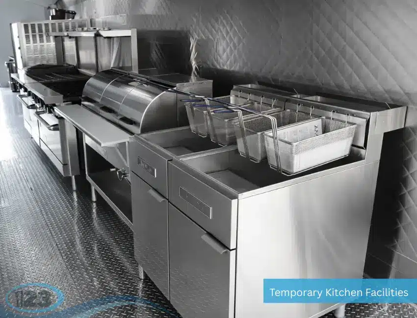 Portable commercial kitchen featuring deep fryers, prep counters, and stainless steel workstations for high-volume meal preparation.
